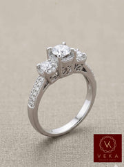 Top-down view of a three-stone engagement ring featuring 80 micro-pavé diamonds on a 14K white gold band