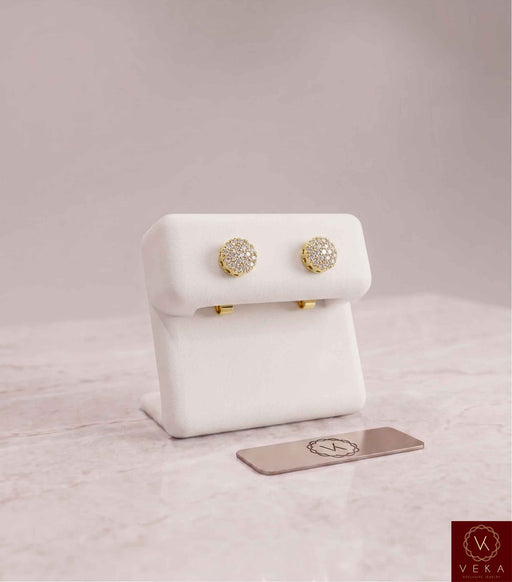 A pair of 0.24 CTW round brilliant lab-grown diamond halo stud earrings in 10k yellow gold, elegantly presented on a white display stand. Veka Jewelry fine fine jewelry collection.