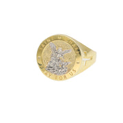 A top-down, slightly elevated studio product photograph of the 10K Two-Tone Gold Saint Michael Signet Ring, showing the complete central face and the upper part of the band