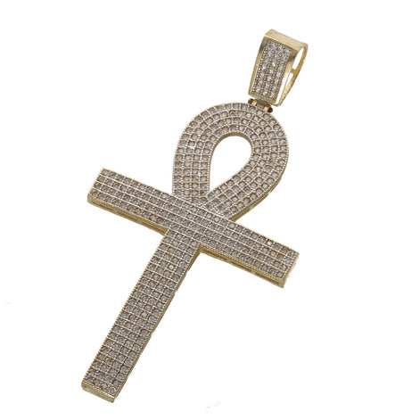 Gold cross-shaped pendant with diamond-like stones on a white background