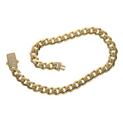 A 10 karat gold cuban link monaco style anklet with a zirconia stone push to open clasp.