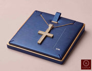 A 10K Real gold cross pendant  with pavé-set clear cz stones, displayed on a blue rectangular jewelry box with gold trim. The box lid has a small blue ribbon loop and a printed measurement mark reading 50 MM.