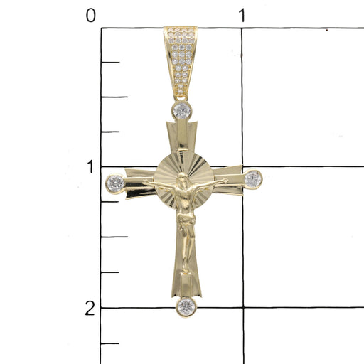 10K gold Jesus Christ crucifix cross pendant with cubic zirconia stones on a grid to have a size reference