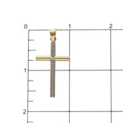 10K gold cross pendant two tones in ruled background as a size reference.