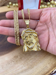 10K solid gold Jesus face pendant with Italian Cuban curb chain on a hand to have a size reference. Where the Pendant with clear stones shows details and how big the bail is and the lobster lock of the chain too.