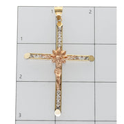 10K two-tone gold crucifix on a ruled background