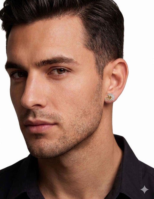 A male model wearing a 10k gold football helmet stud earring paved with 3/8 ctw natural diamonds by VEKA JEWELRY.