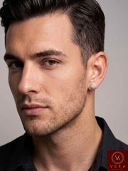 Side profile of a handsome male model wearing an 8mm 10K yellow gold natural diamond halo stud earring on his ear lobe