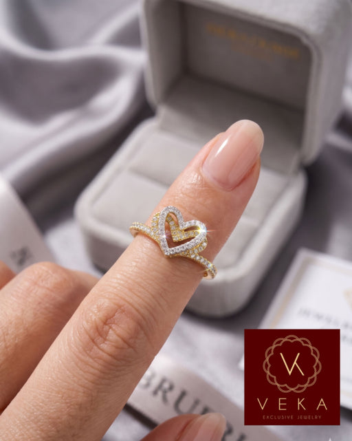 Close-up of a woman wearing a 10K gold interlocking heart promise ring with 0.18 CTW natural diamonds - VEKA JEWELRY fine jewelry.
