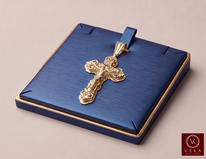 Angled view of genuine 10K yellow gold ornate nugget crucifix charm in luxury packaging
