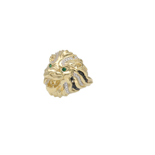 Detailed angle view of a gold lion ring featuring green synthetic emerald eyes and black stone accents in the mane.