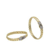 Professional jewelry display of two Monaco 10k gold bangles showing the sleek Miami link construction and Swarovski accents