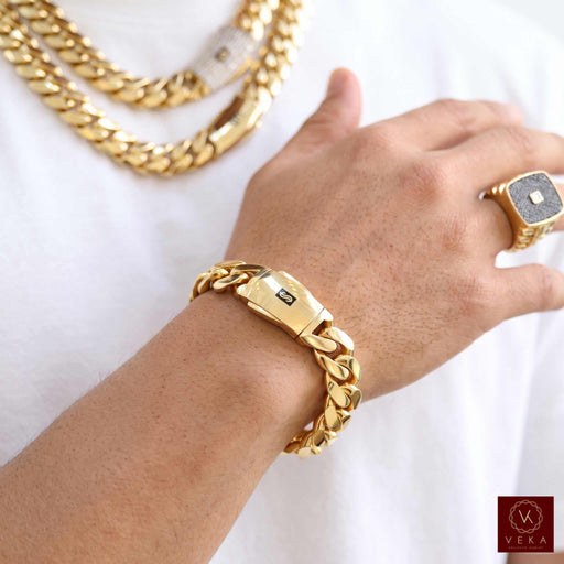 Detailed shot of the ultra-secure double-click box clasp on a 10 karat yellow gold Monaco Cuban link bracelet worn on a wrist without tattoos.