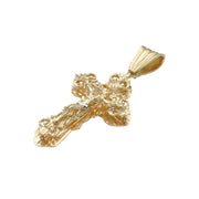 Side angled view showing high-polish grooved bail and textured nugget frame on 10K gold cross