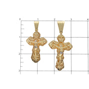 Size comparison between 64mm and 75mm 10K yellow gold nugget crucifix pendants on measuring grid