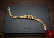 10K yellow gold Princess link bracelet with a tapered semi-solid design displayed on a black Veka Jewelry presentation box.