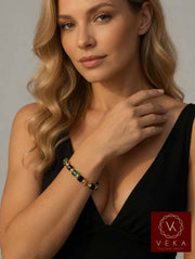 Elegant blonde woman wearing 10K yellow gold red Swarovski crystal adjustable bracelet on her wrist