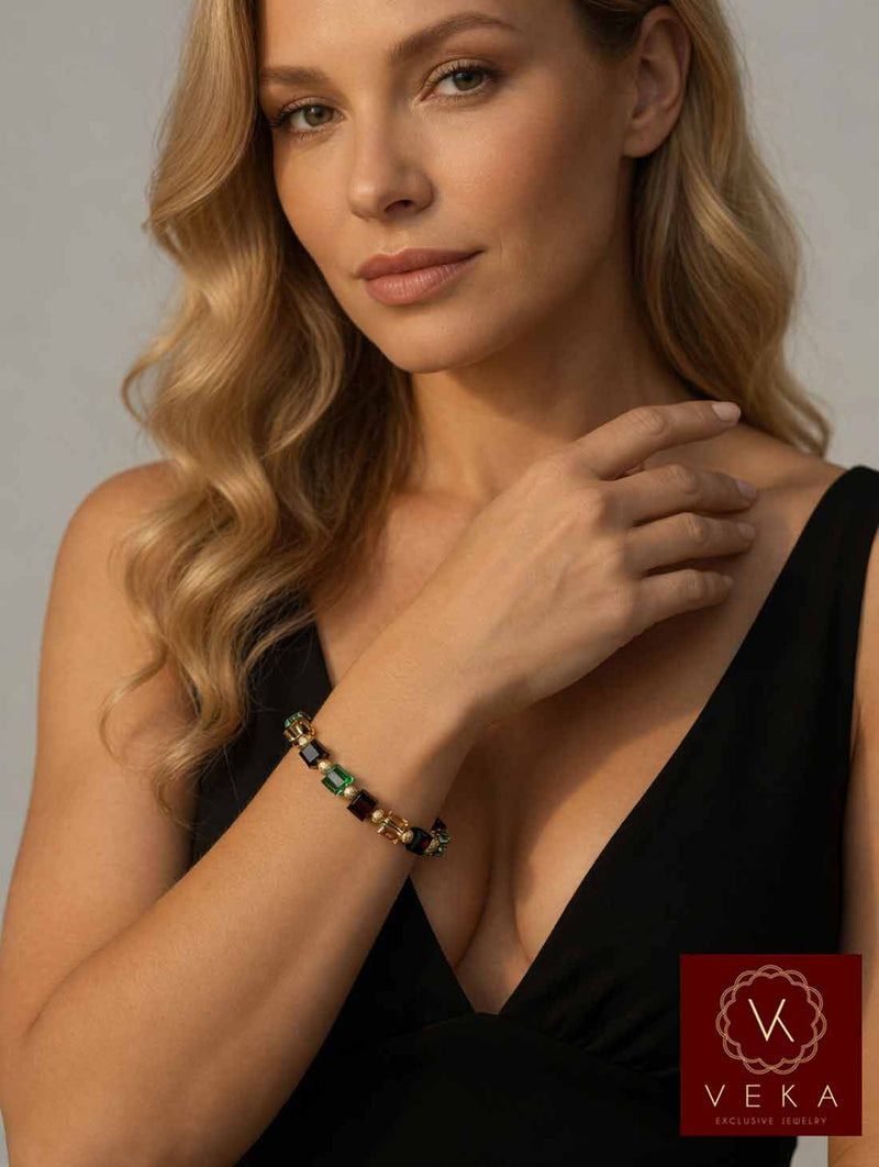 Elegant blonde woman wearing 10K yellow gold red Swarovski crystal adjustable bracelet on her wrist
