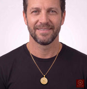 Front view of male model wearing the 10K two-tone gold Santa Barbara medallion pendant on a gold link chain by Veka Jewelry