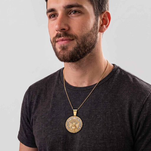 Male model wearing a 10K yellow and white gold Santa Barbara pendant on a gold link chain showing on-body scale and drape
