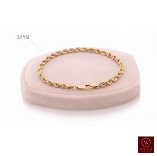 A 10k Yellow gold of 3.5mm rope chain bracelet displayed on a light pink velvet jewelry cushion against a white background at Veka Jewelry