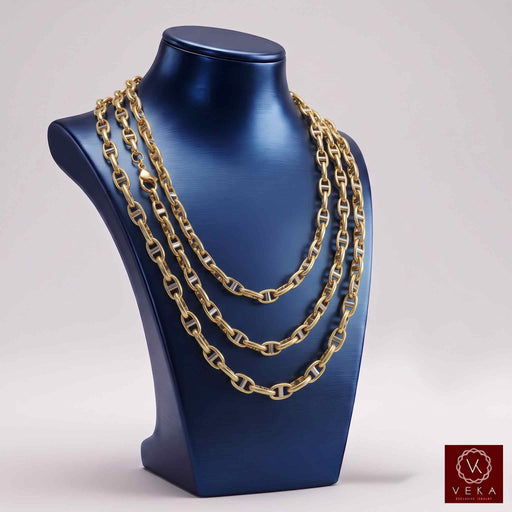 6mm 10K two-tone gold mariner anchor link chain layered on blue jewelry display bust by VEKA Jewelry
