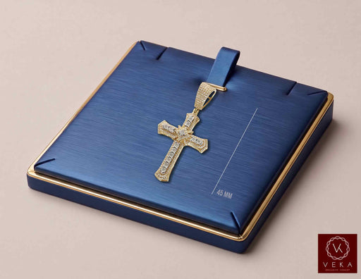 10K yellow gold 0.45 CTW natural diamond flared cross pendant presented on a luxury blue jewelry display tray by Veka Jewelry