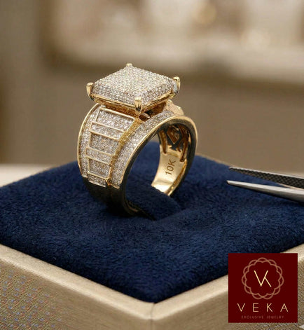 A professional studio shot of a 10K yellow gold engagement ring featuring a 1 carat total weight (1ctw) natural diamond pave setting, displayed on a navy blue velvet jewelry cushion with VEKA branding.