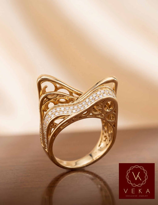 Front view of VEKA Jewelry 10k yellow gold cocktail ring featuring intricate filigree design and brilliant CZ stones on a reflective wooden surface