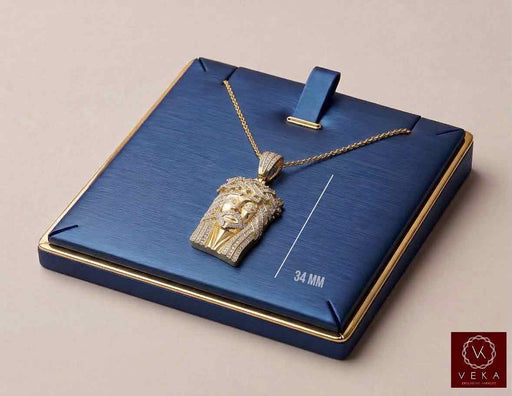 10K Yellow Gold Diamond Jesus Piece Small Pendant 0.40 ctw on blue luxury display stand with 34 mm measurement by Veka Jewelry