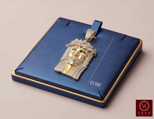 10K yellow gold Jesus face pendant with 1.85 CTW natural diamonds on a luxury navy blue display by Veka Jewelry