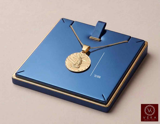 10K yellow gold Saint Lazarus San Lazaro medal pendant displayed on luxury navy blue jewelry stand by Veka Jewelry