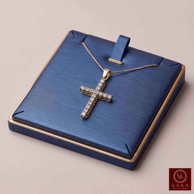 A 10k gold cross pendant encrusted with clear natural diamond stones, displayed on a blue jewelry box with gold trim. The necklace chain is draped over the box lid.