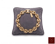 10mm puff mariner link bracelet in 14K yellow gold displayed on a grey velvet pillow by Veka Jewelry