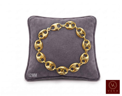 12mm puff mariner link bracelet in 14K yellow gold displayed on a grey velvet pillow by Veka Jewelry