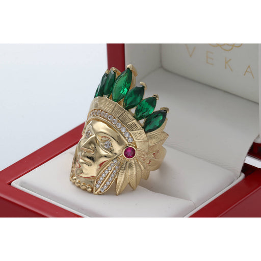 Close-up angled view of the Men's 14K Yellow Gold Indian Chief Ring (13.3g) by Veka Jewelry, featuring a detailed headdress set with emerald green marquise-cut synthetic stones and clear cubic zirconia accents, displayed in a red ring box