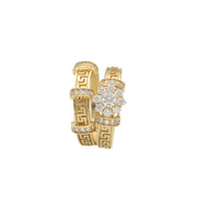A 14 karat gold dual-tone wedding ring set with a geometric maze design, featuring a prominent zirconia flower on one of the rings.