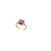 14K yellow gold ruby red zircon ring on a white background.