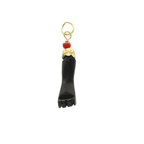 A 14 karat gold black figa hand real azabache pendant with a red coral attachment.