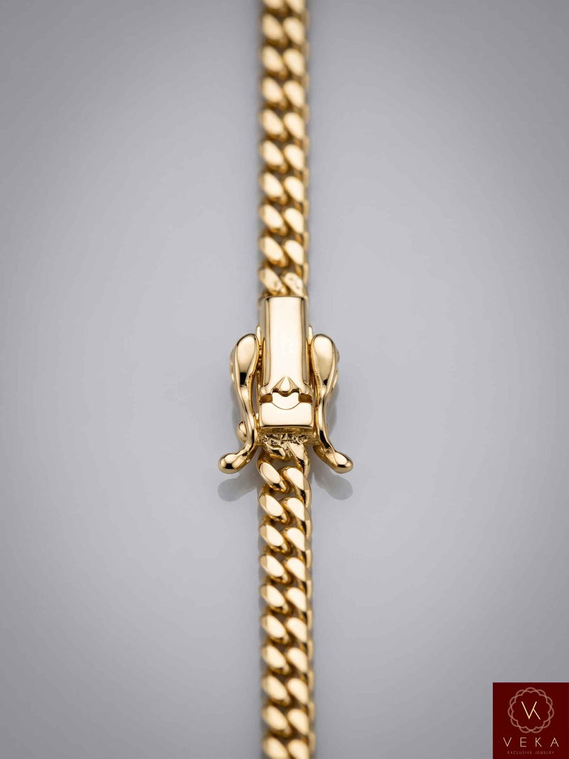 Close-up detailed shot of a secure premium box lock clasp on a 14K solid gold 4mm Miami Cuban link chain by Veka Jewelry.