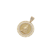 Detailed angled view of 14 karat yellow gold Caridad del Cobre charm showing pavé CZ bail and embossed finish