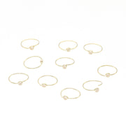 Gold rings with small stones on a white background