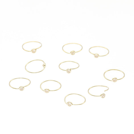 Gold rings with small stones on a white background
