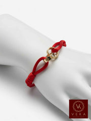 14K gold two band passion red macrame bracelet with screw head design displayed on white jewelry hand form