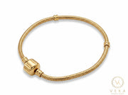 14K real yellow gold snake chain charm bracelet with barrel snap clip clasp on clean white background - Veka Jewelry.