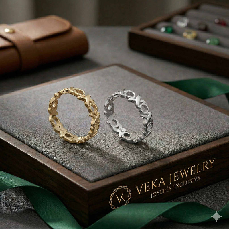 Pair of 14k solid gold XOXO eternity bands in white gold and yellow gold on a luxury black jewelry box