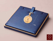 14K two-tone gold Virgen de la Caridad del Cobre medal pendant displayed on luxury blue jewelry pad showing 34 mm height measurement by Veka Jewelry