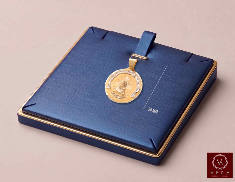 14K two-tone gold Virgen de la Caridad del Cobre medal pendant displayed on luxury blue jewelry pad showing 34 mm height measurement by Veka Jewelry