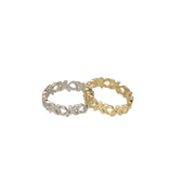 Two rings, one gold and one white gold, on a white background
