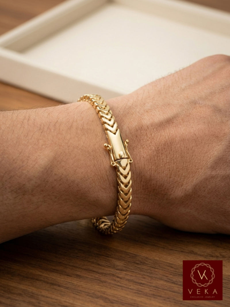 Close-up of a man wearing a 14K yellow gold 5mm Franco chain bracelet showcasing fit and proportion on the wrist.